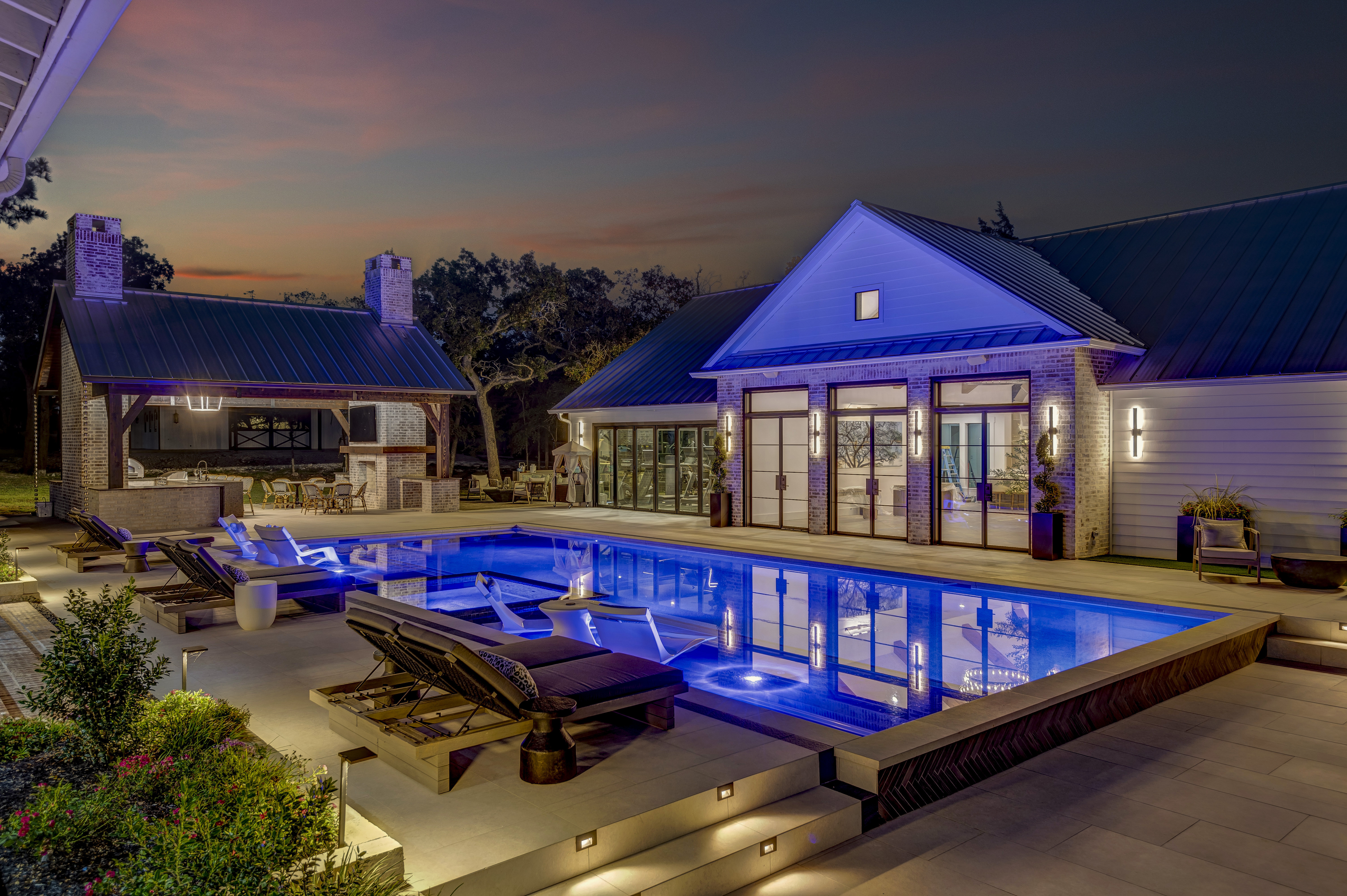 Sunset over a custom pool by Tyde Outdoor Concepts